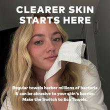White cleansing towel wipe pressed to cheek, close-up portrait with towel