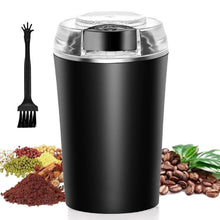 Black electric coffee grinder with transparent lid and cleaning brush