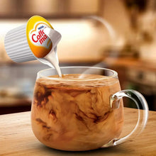 Coffee-mate hazelnut creamer being poured into mug with cream swirl