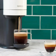 Espresso cups with crema and pour from Nespresso machine