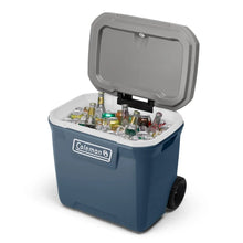 Blue hard chest cooler with hinged lid open, holding drinks bottles inside.