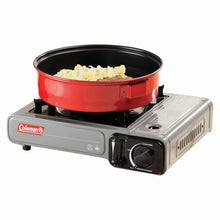 Gray 1-burner portable butane camping stove with red pot on burner