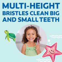 Kid holding a purple ocean explorer toothbrush with soft bristles