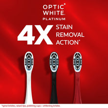Manual toothbrushes for stain removal action, white, black, and red handles.
