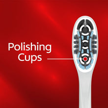 Manual toothbrush head with polishing cup bristle pattern on white handle.