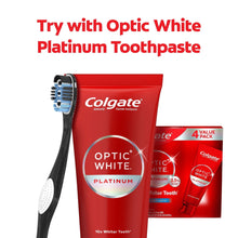 Manual Optic White platinum toothbrush next to red toothpaste tube and pack.