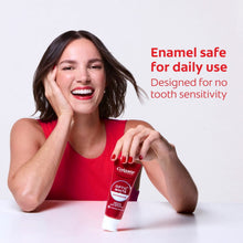 Colgate Optic White Advanced toothpaste tube held by smiling woman in red top