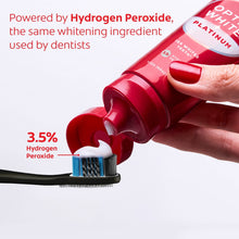 Colgate Optic White Platinum toothpaste tube with toothbrush brush, red