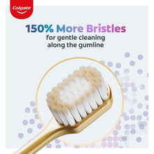 Manual toothbrush with golden handle and dense white bristles in close-up