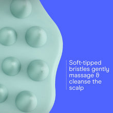 Mint green scalp massager brush head close-up with round silicone massage nubs