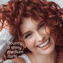 Medium bouncy red curly hair with defined curls and volume.
