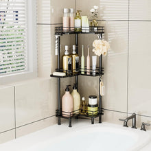 Corner shower caddy with three shelves storing bottles and soap, plus hanging brush