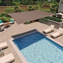 Brown rectangle shade sail over backyard patio above a swimming pool