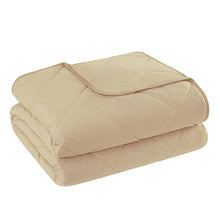 Folded beige cooling blanket with quilted stitching and smooth top layer
