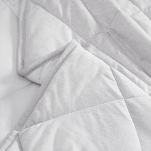 Light gray quilted cooling throw blanket close-up of stitched fabric