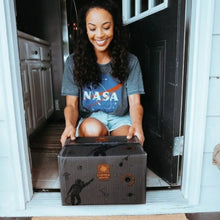 Coffee bag shipment box being carried at an entryway