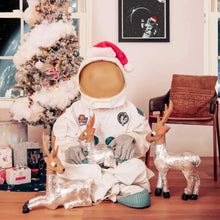 White Christmas coffee pods and foil sleeves with holiday-themed decorations