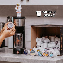 Single-serve coffee pods with coffee machine and stacked pod cups