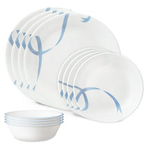 Glass dinnerware set with white plates and bowls, light blue ribbon vine pattern