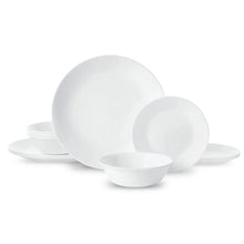 White glass dinnerware set with stacked plates and shallow bowls