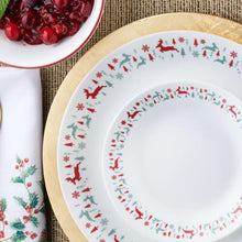 Close-up of white dinner plate rim with red and green reindeer border