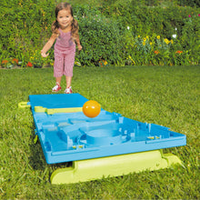 Blue cornhole board with green base, orange bean bag and ball on grass