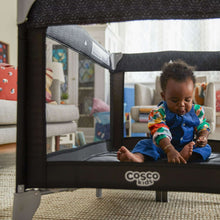 Portable baby play yard with mesh side and padded base, Cosco Kids logo visible