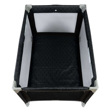 Portable baby play yard top view, black mesh sides and padded play mat