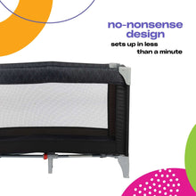 Mesh side panel of a dark baby play yard with corner clamp and foot supports
