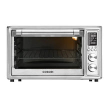 Silver air fryer toaster oven with open door and empty dark interior