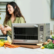 Silver air fryer toaster oven with front control panel and open cooking cavity