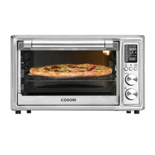 Silver air fryer toaster oven with round pizza inside