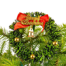 Decorated Norfolk pine tree with red bow and gold ornament baubles in green foliage