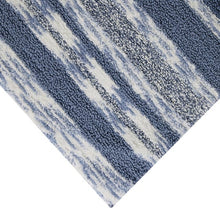 Blue striped cotton bath mat corner, textured pile and vertical stripe pattern