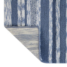 Blue striped cotton bath mat showing textured pile and vertical stripe design