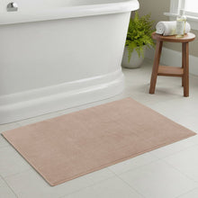 Beige cotton woven bath mat with low-pile texture