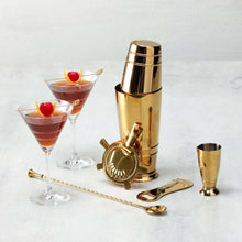 Gold bartender essentials set with shaker, jigger, bar spoon, and citrus strainer