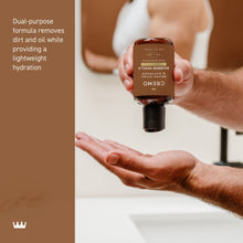 Cremo 2-in-1 beard and face wash bottle dispensing into a palm