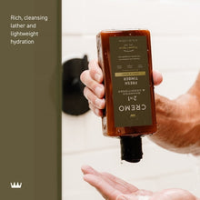 2-in-1 shampoo and conditioner bottle held by hand, back label facing camera
