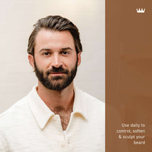 Bearded man holding a beard & scruff cream jar, white shirt, close view