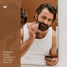 Man applying beard & scruff cream from a small jar to his beard