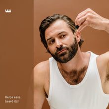 Bearded man with facial hair while applying Cremo Bourbon Vanilla beard oil