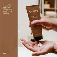 Cremo shave cream tube squeezed onto palm, Bourbon Vanilla, brown with black cap