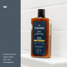 2-in-1 shampoo & conditioner bottle with Palo Santo label, standing in a shower