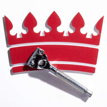 Razor resting on red crown-shaped foam pads