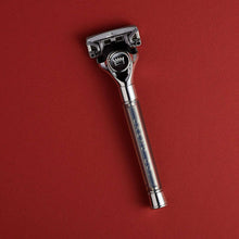Metallic razor with blade head and textured grip area