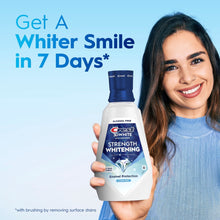 Crest strength whitening alcohol-free mouthwash bottle held by smiling woman