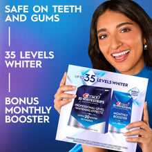 Crest 3D Whitestrips whitening kit held by smiling person, with booster package