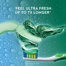 Toothpaste and toothbrush with mint-green gel splash over blue water droplets