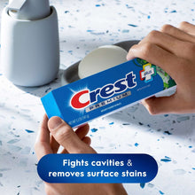 Crest Premium Scope toothpaste box held in hand, mint